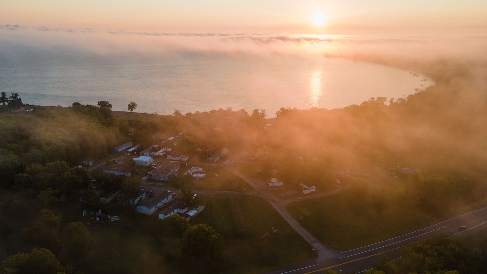 Aerial view of Twilight Cove at sunrise, morning mist rolling over Cove Bay on Lake Mille Lacs