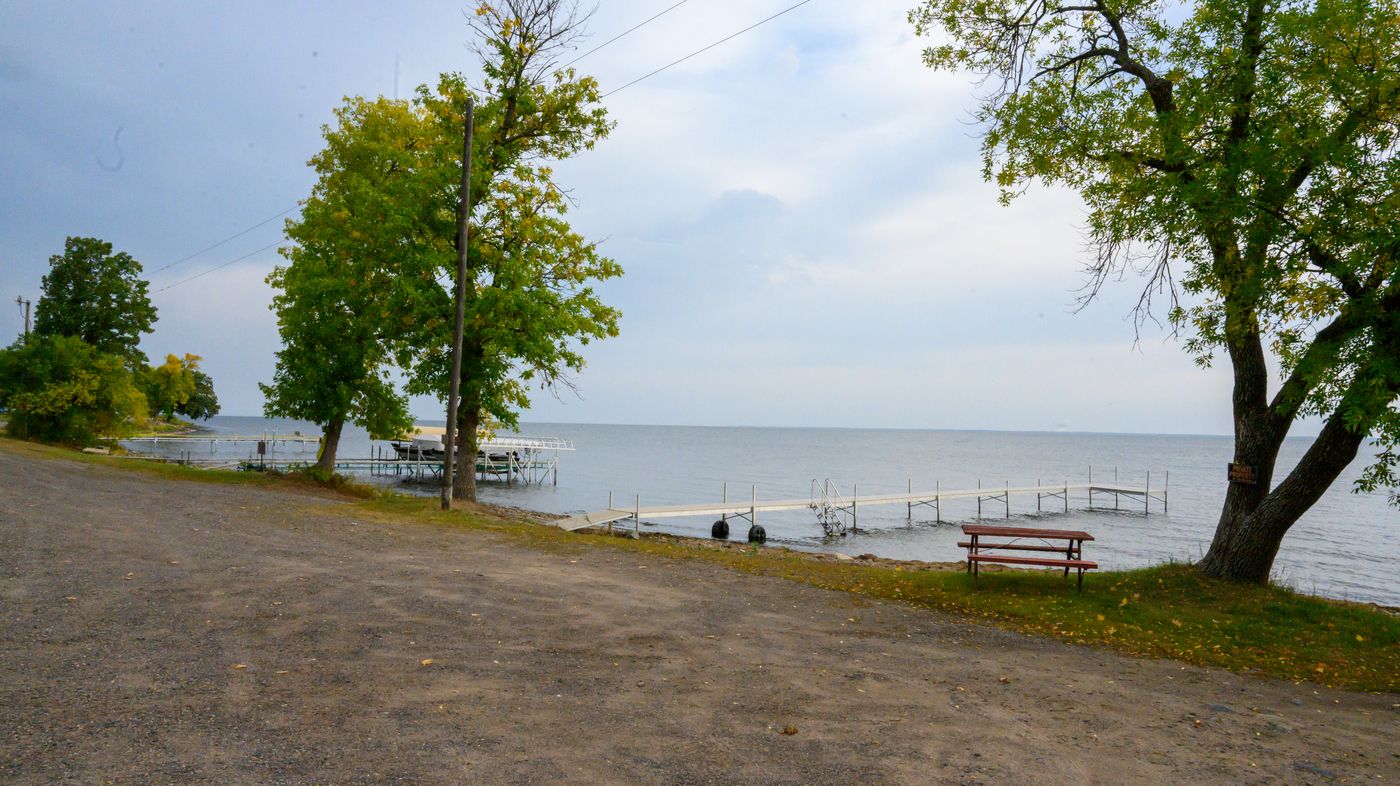Lakeside picnic area under mature shade trees at Twilight Cove