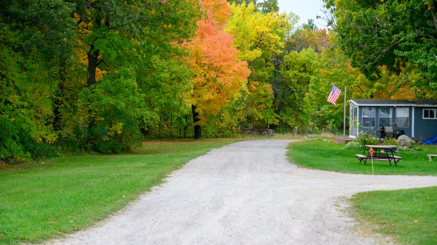 RV site at Twilight Cove with full hookups surrounded by fall color